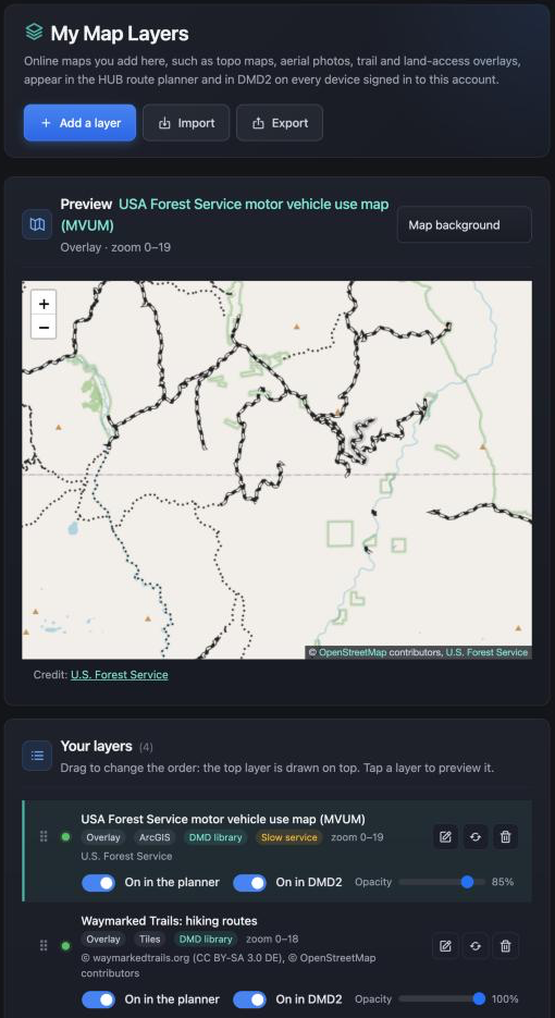 My Map Layers: the Preview map showing the US Forest Service motor vehicle use map over Idaho, and below it Your layers with MVUM, Waymarked Trails hiking routes and OpenTopoMap, each with status dot, tags, On in the planner and On in DMD2 switches and an opacity slider